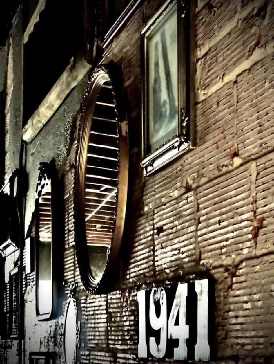 Gilded mirrors and the 1941 sign on the old brick wall