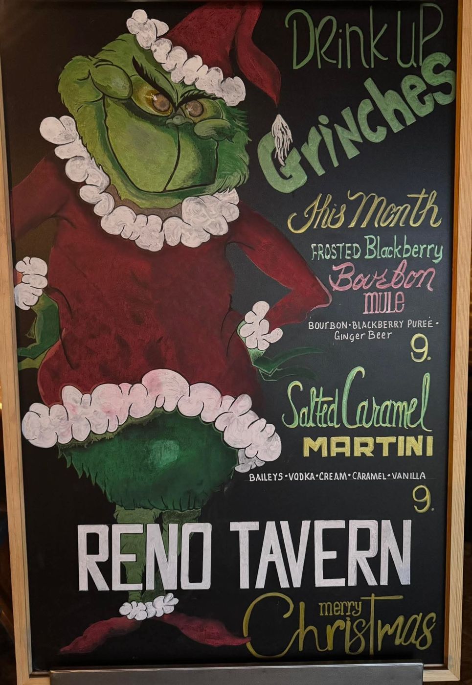 Hand-drawn Grinch chalkboard with December cocktail specials