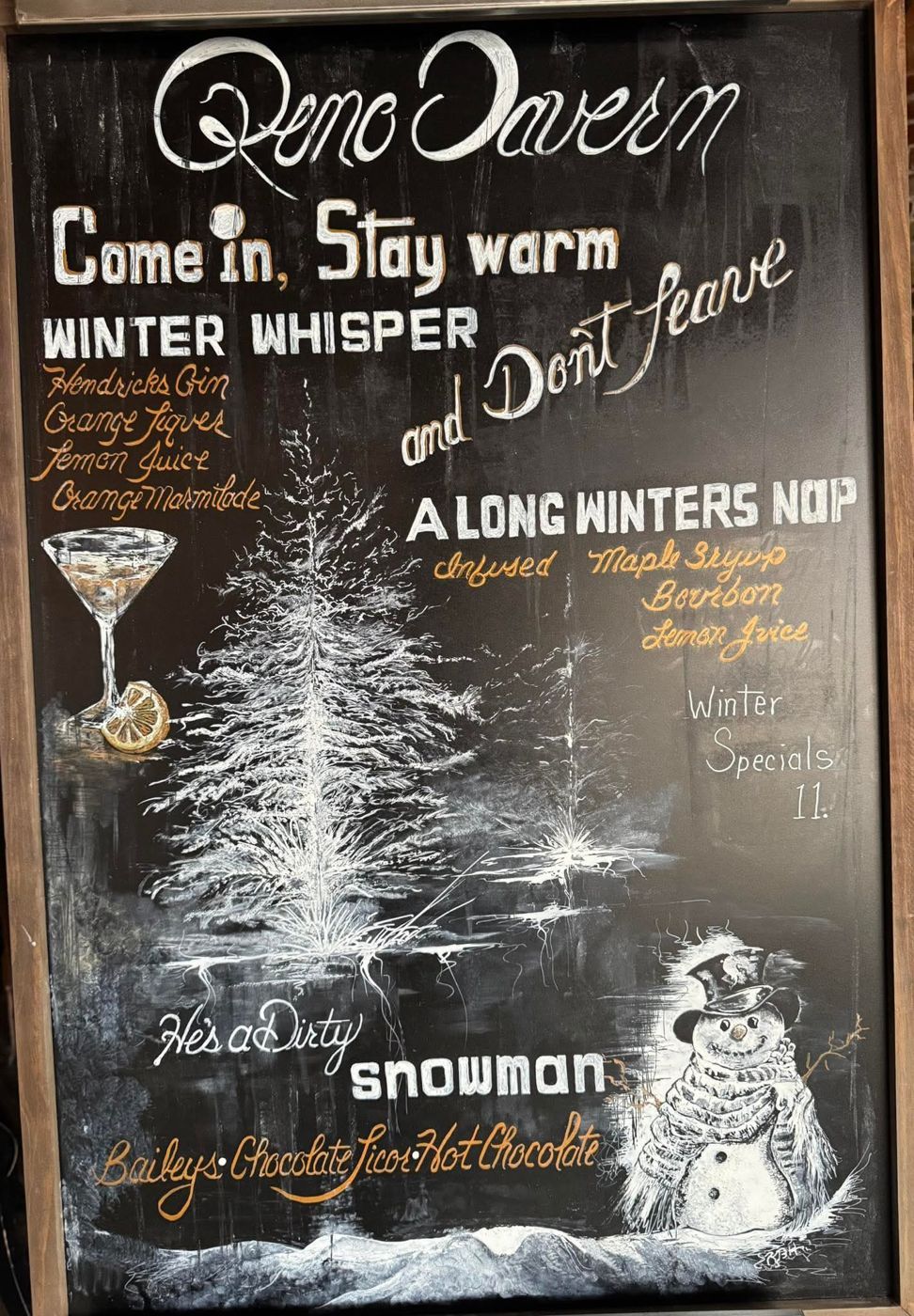 Hand-drawn winter specials chalkboard with a pine tree and snowman