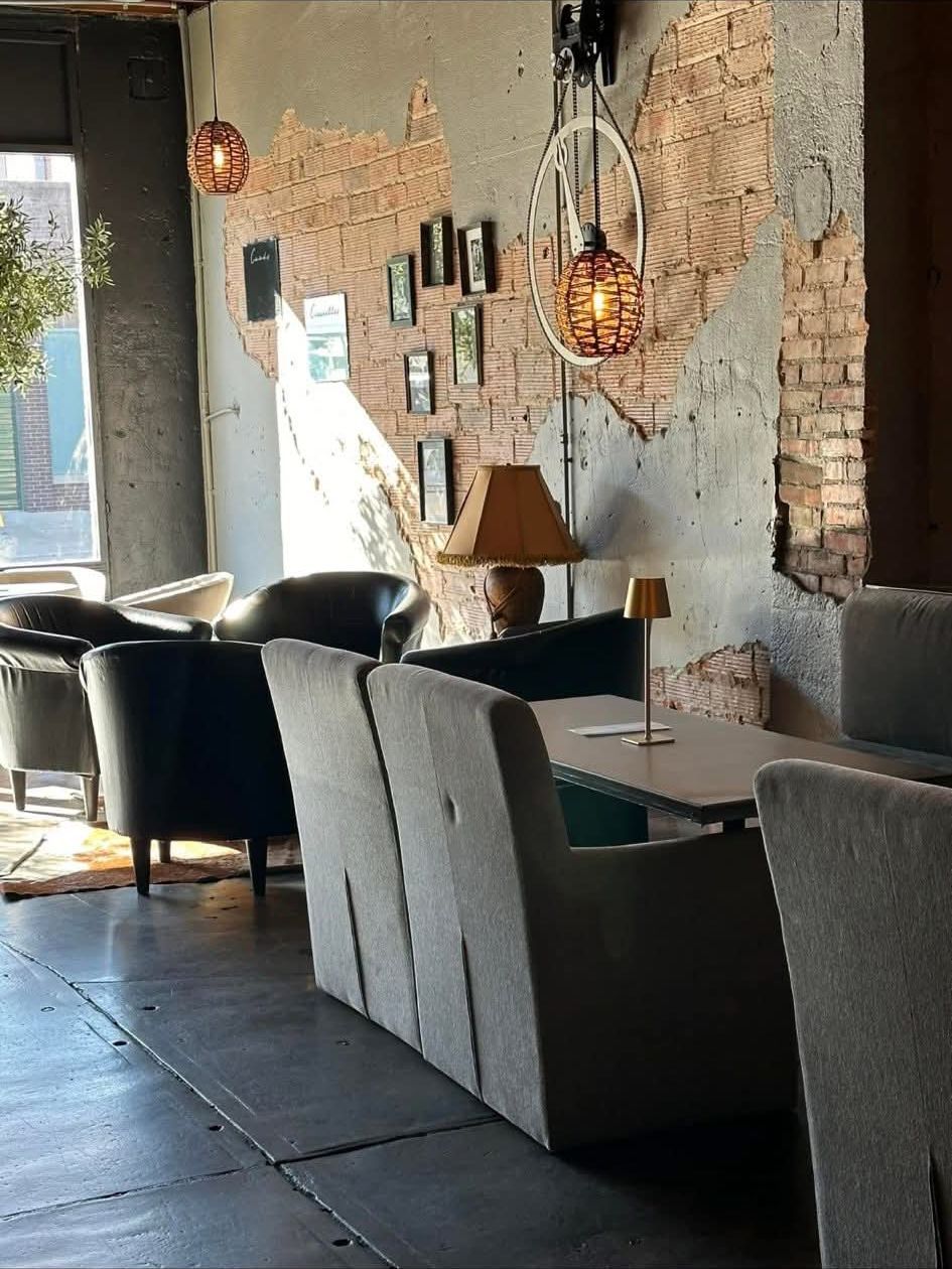 Leather club chairs against the exposed brick wall