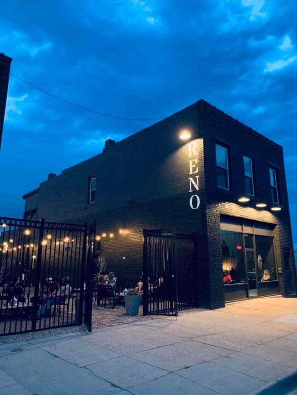 The Reno at dusk with the patio full under string lights
