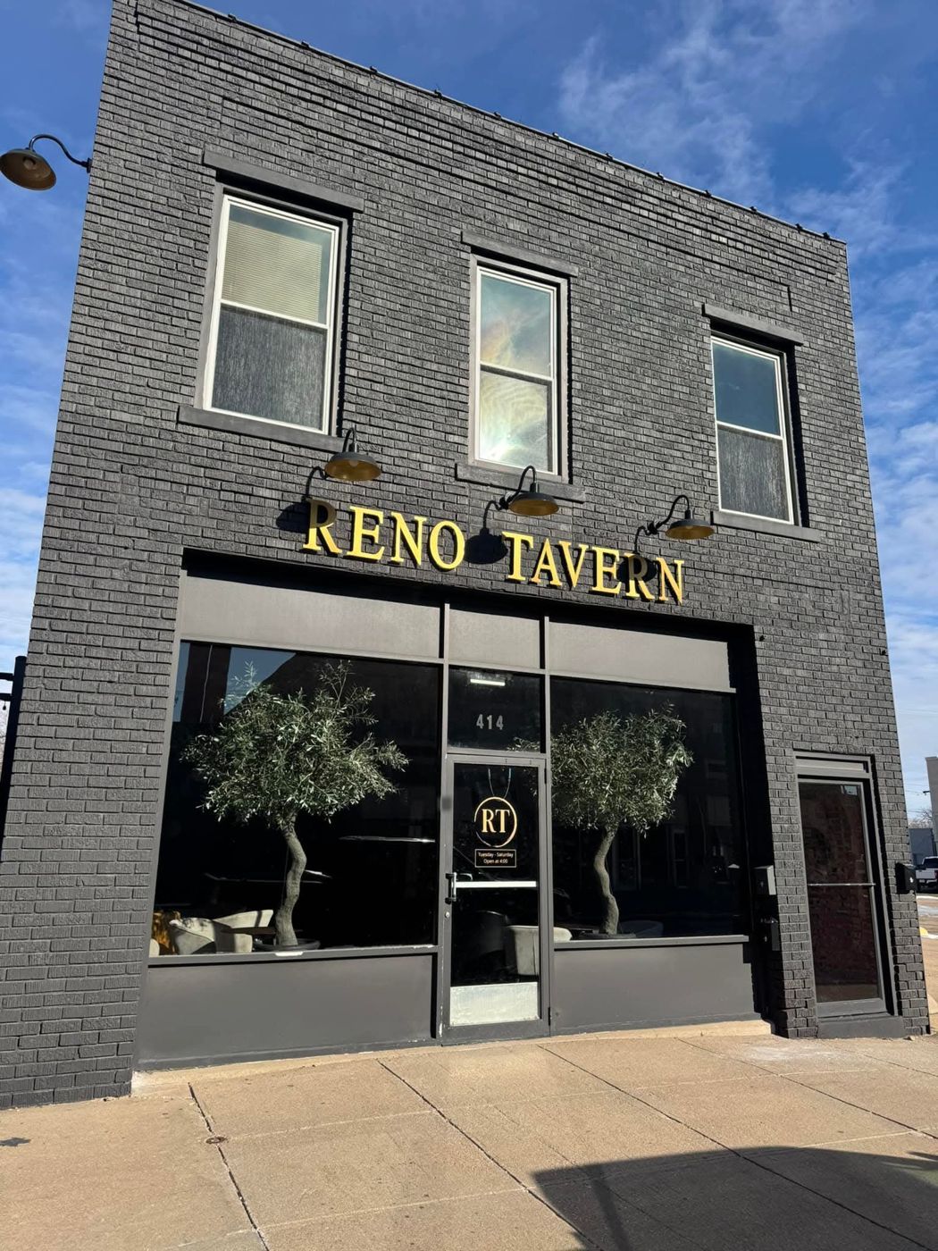 The Reno Tavern storefront on West 2nd Street with gold lettering and the RT logo on the door